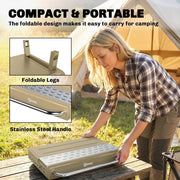 Khaki Outsunny BBQ grill folded and carried by its stainless steel handle, showing the foldable legs
