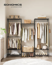 Ink black open wardrobe styled with clothes, bags and shoes in a bedroom
