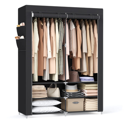 Black portable wardrobe filled with clothes, bags and folded linen on a white background