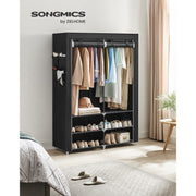 Black portable wardrobe styled in a bedroom next to a bed and a rug