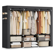 Wide black portable wardrobe filled with clothes and storage boxes on a white background