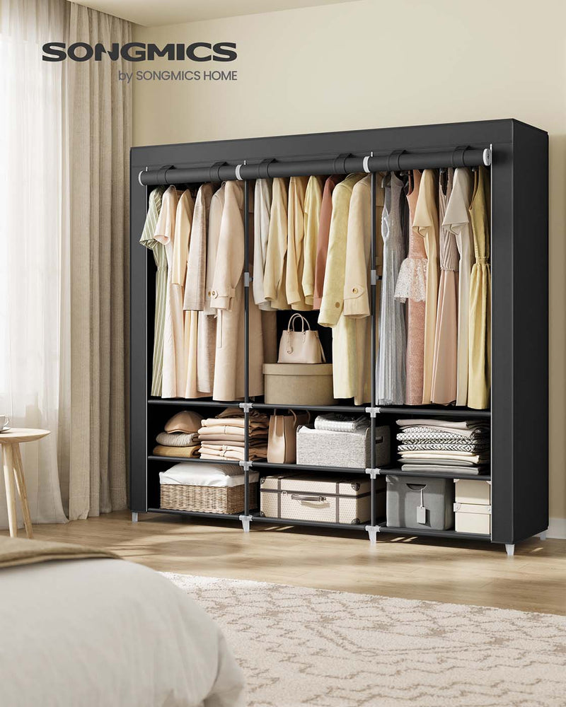 Wide black portable wardrobe styled in a bedroom beside a bed and curtains