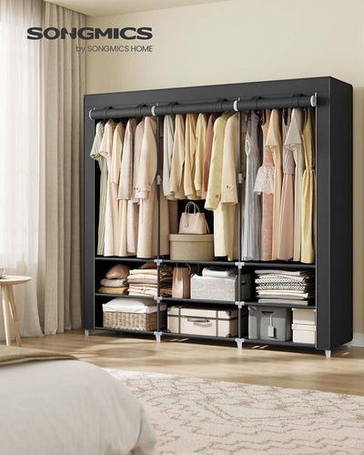 Wide black portable wardrobe styled in a bedroom beside a bed and curtains