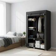 Portable wardrobe open beside a bed, filled with folded clothes, hanging shirts and bags