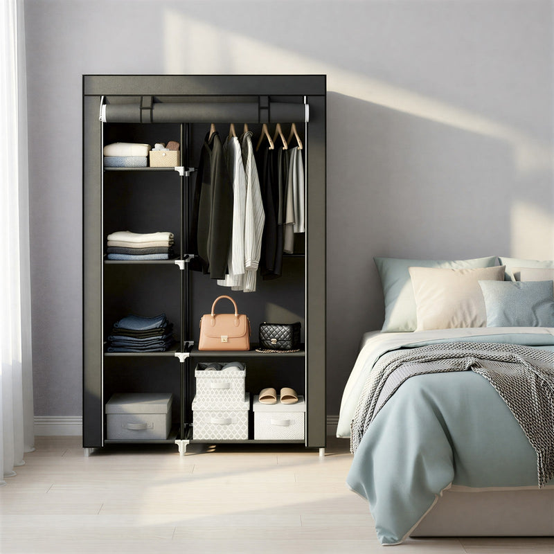 Portable wardrobe styled beside a bed with storage boxes and shoes on the bottom shelf