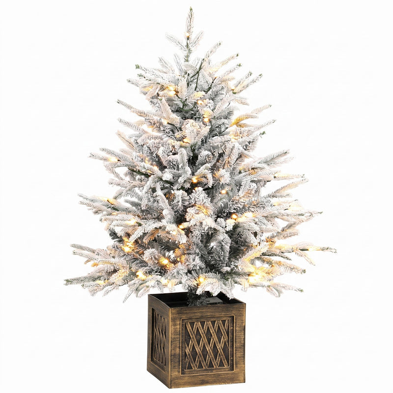 Snow-flocked pre-lit table Christmas tree in a wood-effect base on white