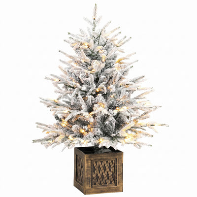 Snow-flocked pre-lit table Christmas tree in a wood-effect base on white
