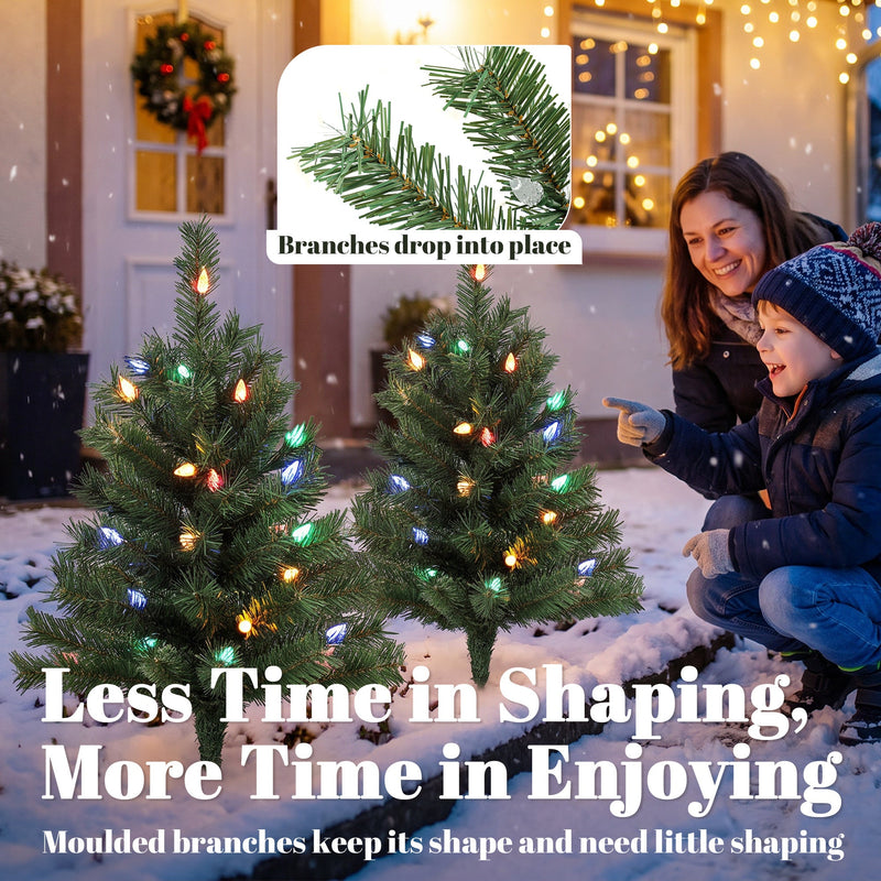 Parent and child with two lit trees in the snow and a branches-drop-into-place inset