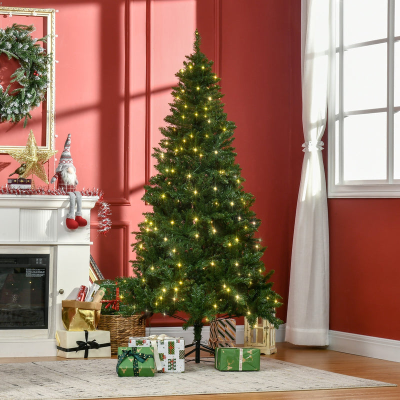 6ft lit Christmas tree with gifts in front of a red wall and fireplace