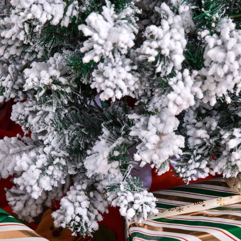 Close-up of frosted branches above wrapped gifts on the 4ft tree