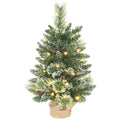 Snow-flocked 60 cm tabletop Christmas tree with warm white LEDs and a linen-look base on white
