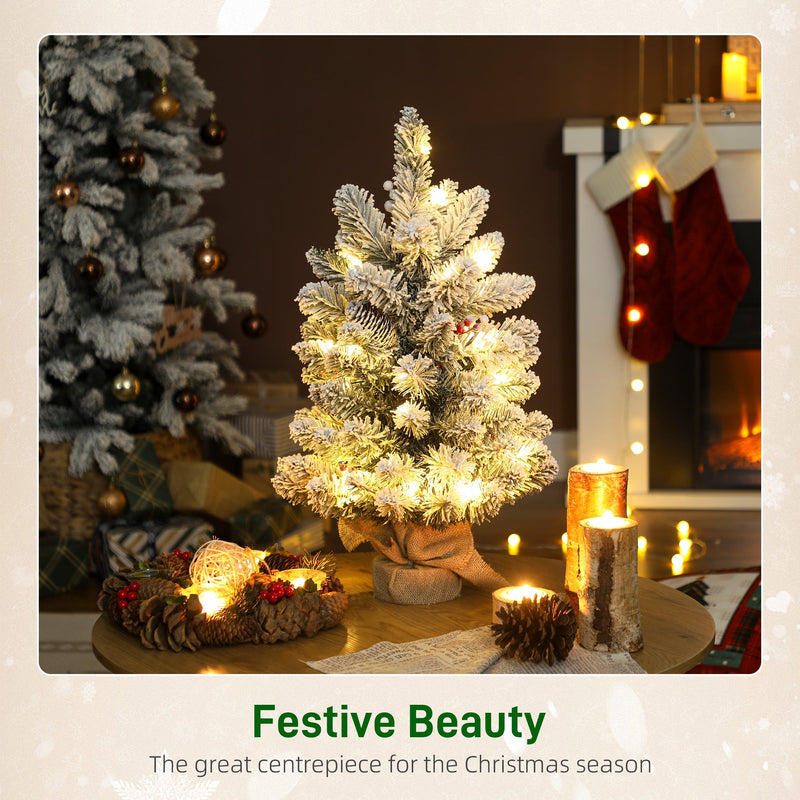 Festive Beauty scene with a glowing slim flocked mini tree on a decorated table