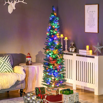 Slim pre-lit Christmas tree with multicoloured lights in a living room corner above wrapped presents