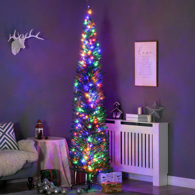 Tall slim pre-lit Christmas tree with multicoloured lights in a purple-lit living room corner