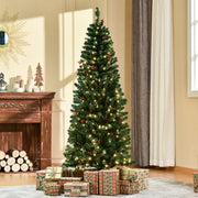 6ft pencil Christmas tree lit up in a living room with wrapped gifts