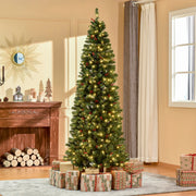 7ft pencil Christmas tree lit up in a bright living room with wrapped gifts