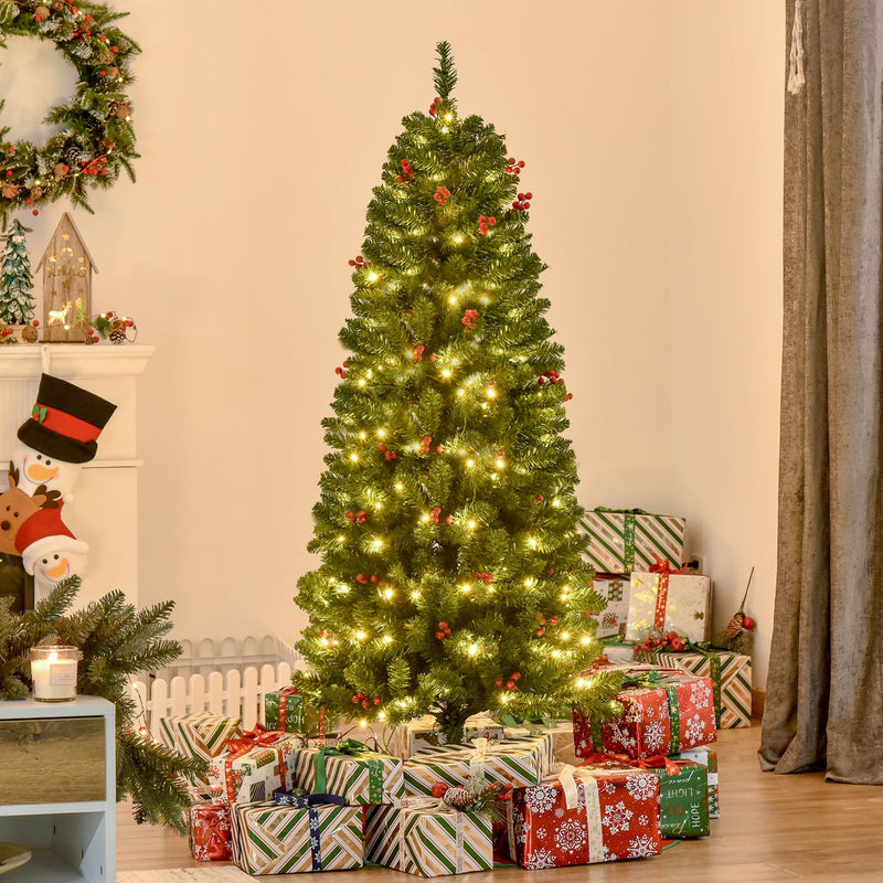5ft pencil Christmas tree lit up in a living room with a wreath and wrapped gifts