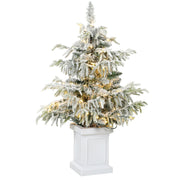 3ft snow flocked Christmas tree with warm white lights in a white pedestal pot on a white background