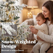 Parent and child by the 3ft snow-weighted flocked tree with a 115 branch tips callout