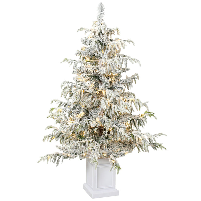 4ft snow flocked Christmas tree with warm white lights in a white pedestal pot on a white background
