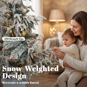 Parent and child by the 4ft snow-weighted flocked tree with a 200 branch tips callout