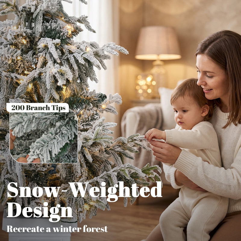 Parent and child by the 4ft snow-weighted flocked tree with a 200 branch tips callout