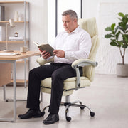 Person reading a book while seated in the reclined beige office chair