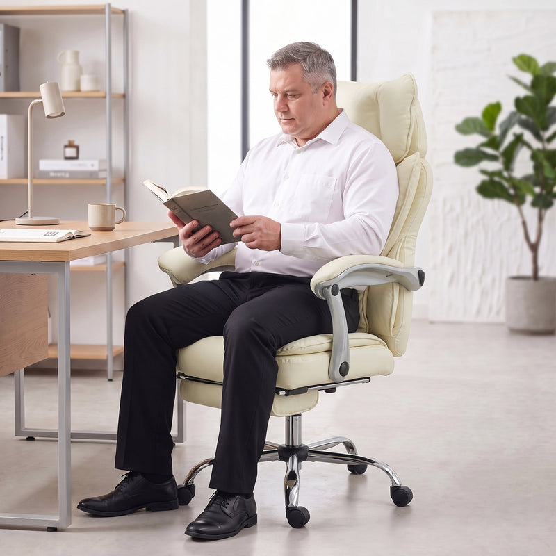 Person reading a book while seated in the reclined beige office chair