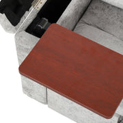Armrest storage compartment with a wood-effect tray folded out on the grey sofa bed