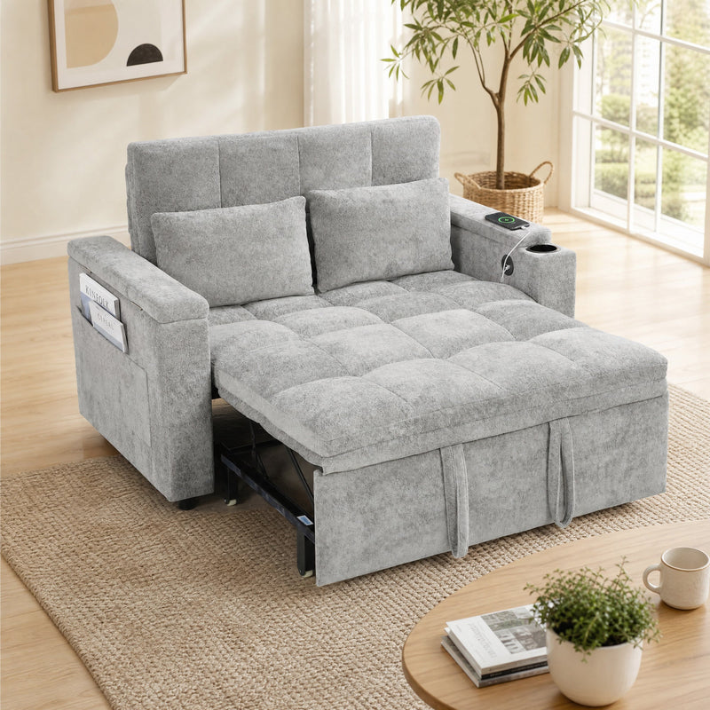 Grey tufted sofa bed with two pillows and the bed extended in a bright living room