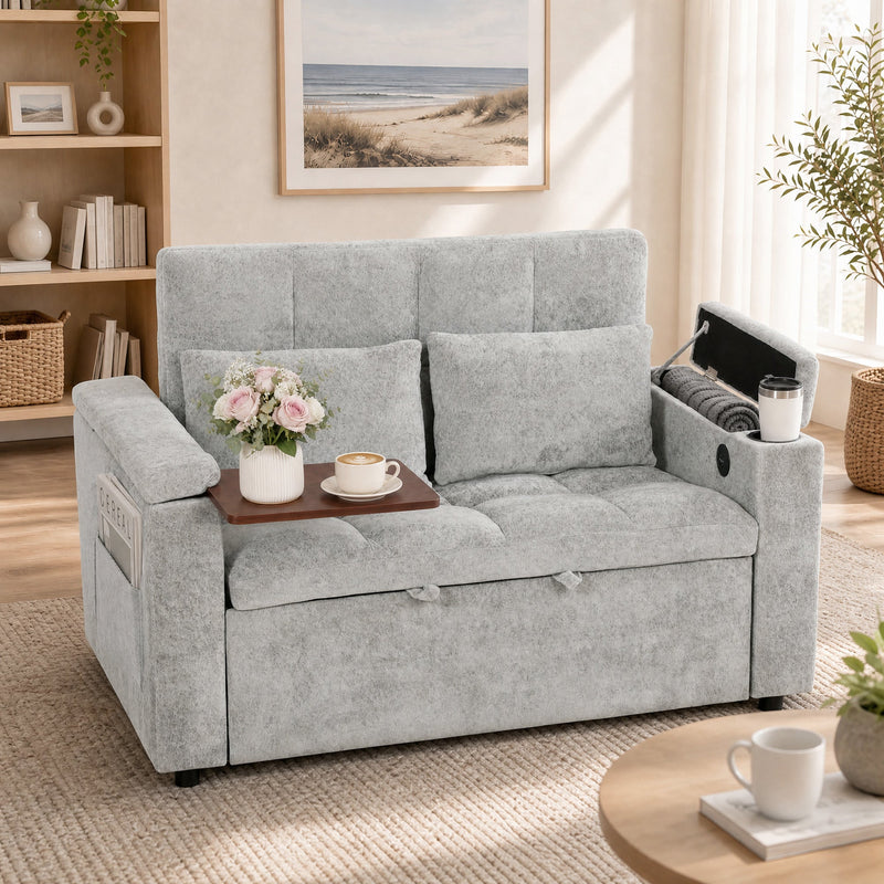 Grey sofa bed with a tray folded out over the armrest holding flowers and coffee