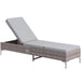 Image of a reclining rattan sun lounger with a light grey cushion 