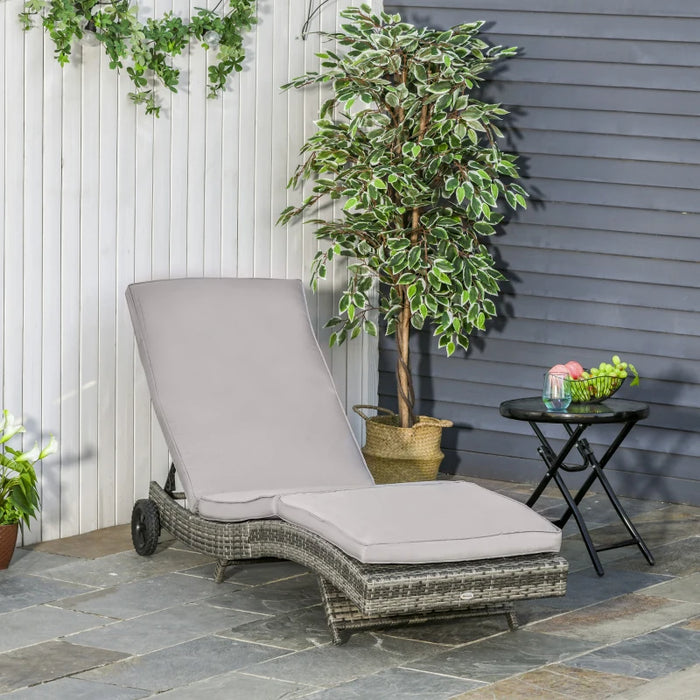 Image of an ergonomic curved rattan sun lounger with cushion and wheels 