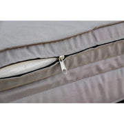 Image of an ergonomic curved rattan sun lounger with cushion and wheels 
