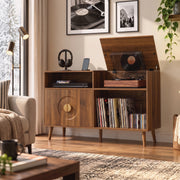 Walnut record player stand in a living room with framed record artwork on the wall