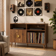 Walnut record player stand in a living room with vinyl album art displayed on the wall