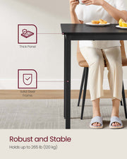 Dining table positioned in a kitchen setting for scale