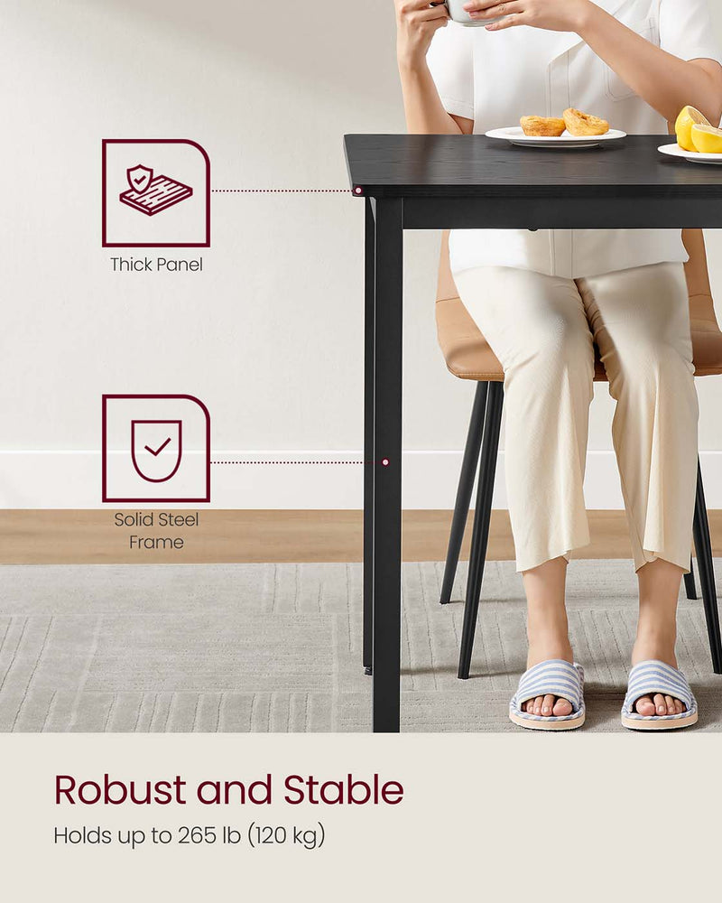 Dining table positioned in a kitchen setting for scale