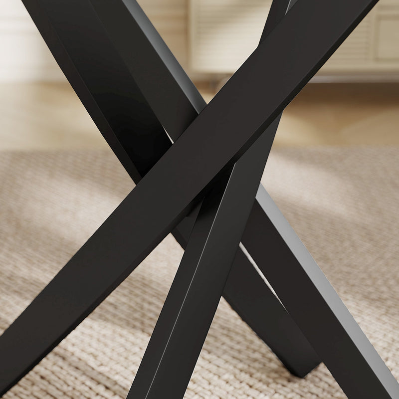 Close-up of black steel cross legs under the glass top