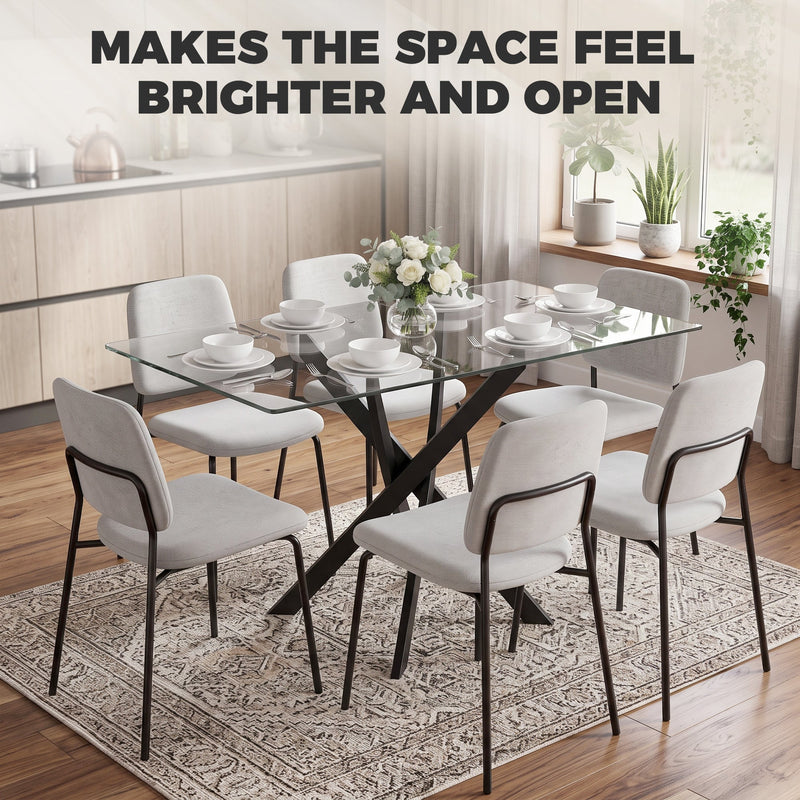 Clear glass table with grey chairs in a bright kitchen, labelled makes the space feel brighter
