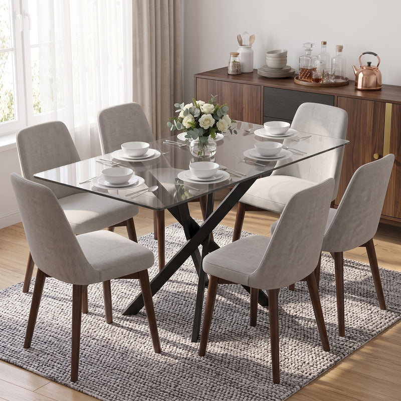Glass dining table with beige chairs and a vase of flowers