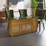 Rectangular glass dining table with matte gold base set for six in a modern dining room