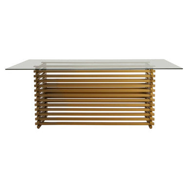 200cm clear glass top dining table on a sculptural matte gold stainless steel base, studio view