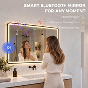 Woman using the black LED bathroom mirror with a Bluetooth music icon showing audio streaming