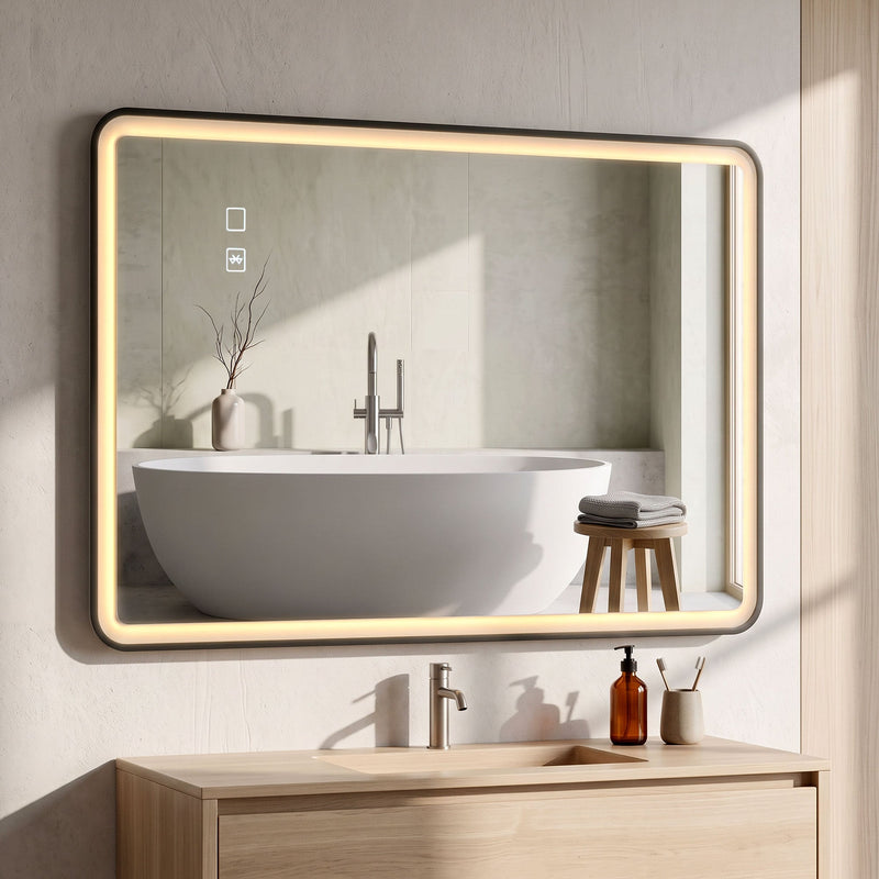 Black LED bathroom mirror mounted horizontally above a wooden vanity with a bath in the reflection