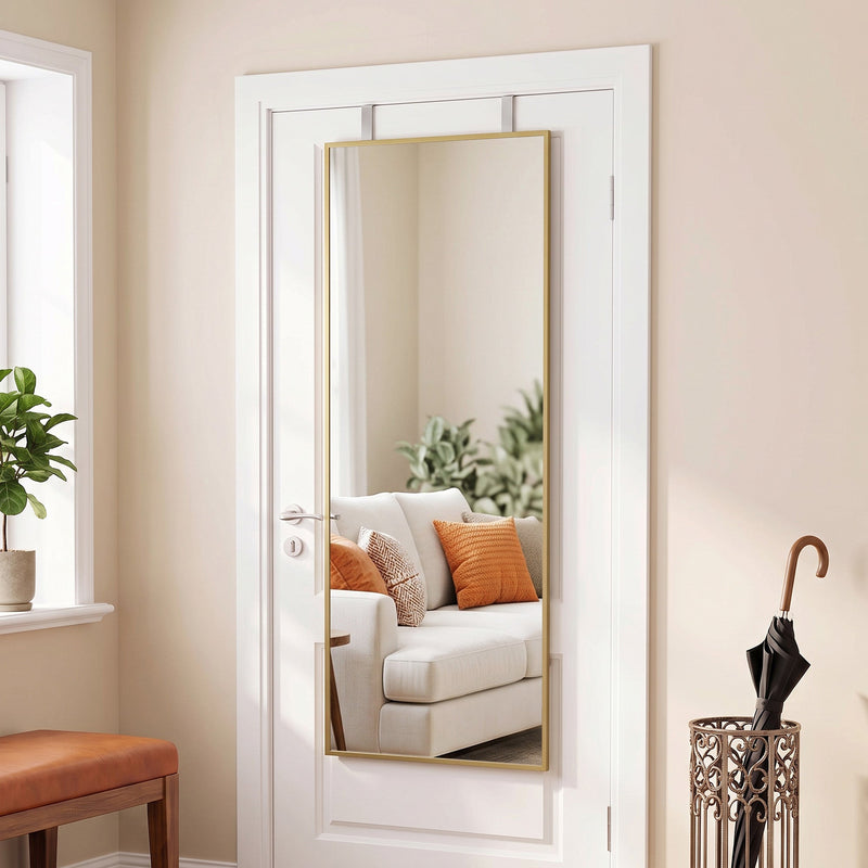 Full length mirror hanging over an interior door beside an umbrella stand