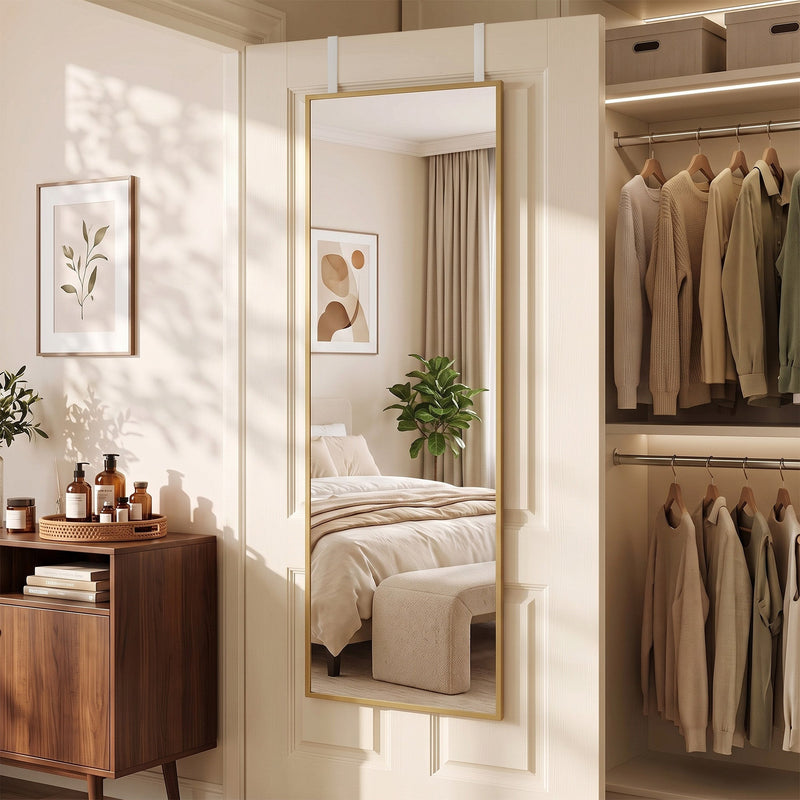 Mirror on a door next to an open wardrobe with hanging shirts