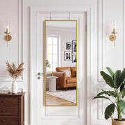 Door mirror in a bright living room with an armchair and plant reflected