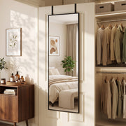 Over-door mirror hanging beside a walk-in wardrobe with folded clothes