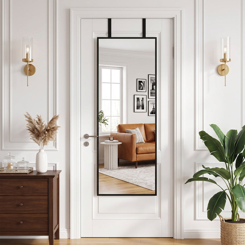 Mirror hanging over a panelled door in a living room with wall lights